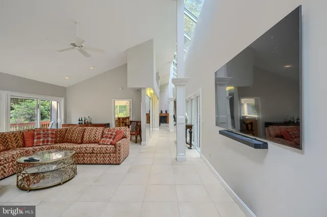 a dining area with furniture and a floor to ceiling window