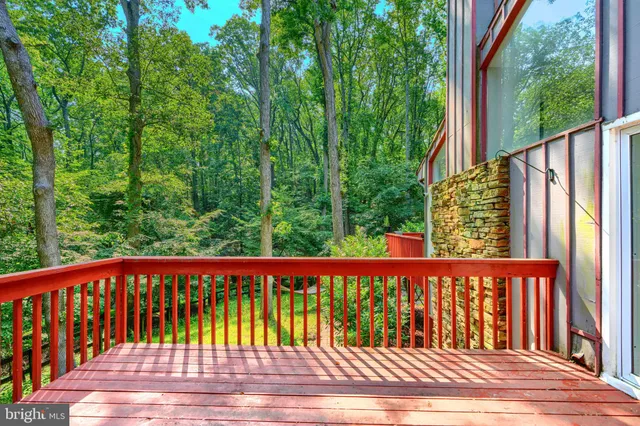 a view of a porch with a table and chairs