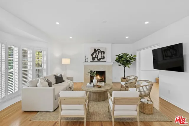 a living room with fireplace furniture and a flat screen tv