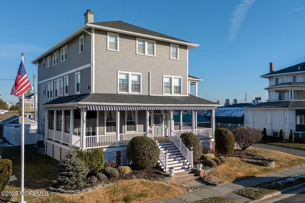 a front view of a house with garden and balcony