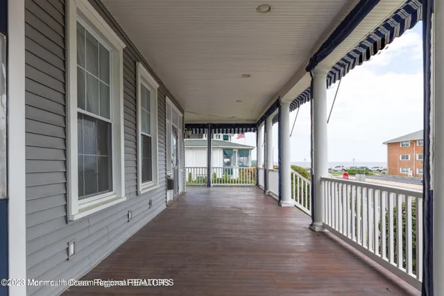 a view of a porch with wooden floor and iron stairs