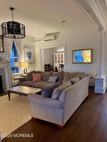 a living room with furniture a rug and a chandelier