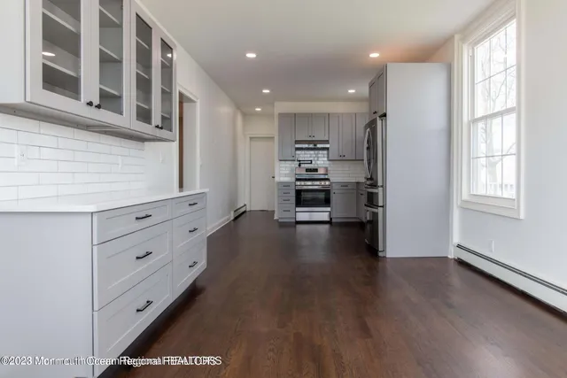 a view of kitchen with refrigerator and window
