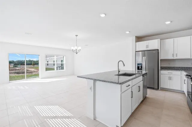 a kitchen with a sink stove and refrigerator