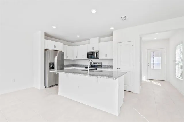 a kitchen with stainless steel appliances a refrigerator stove microwave and cabinets