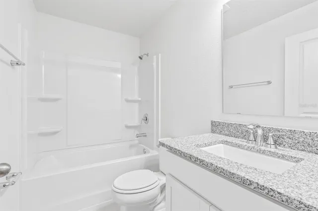 a view of a room with a ceiling fan and window