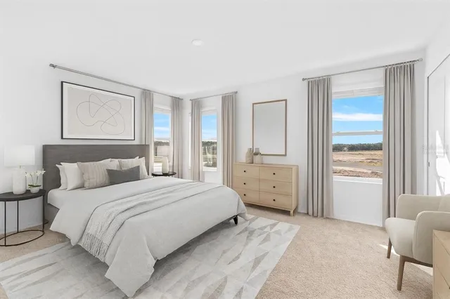 a bedroom with a large bed and a window