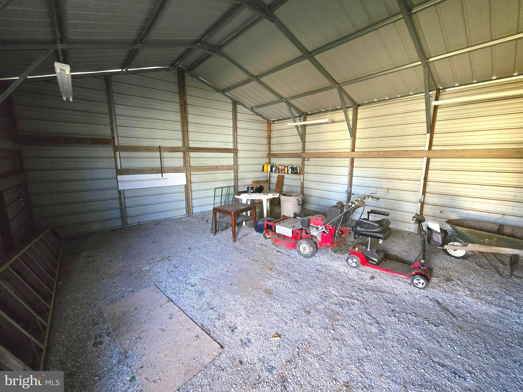 196 Foster Drive Falling Waters, WV 25419 - Photo 26 of 50 a view of a garage with the back of the house and cars parked