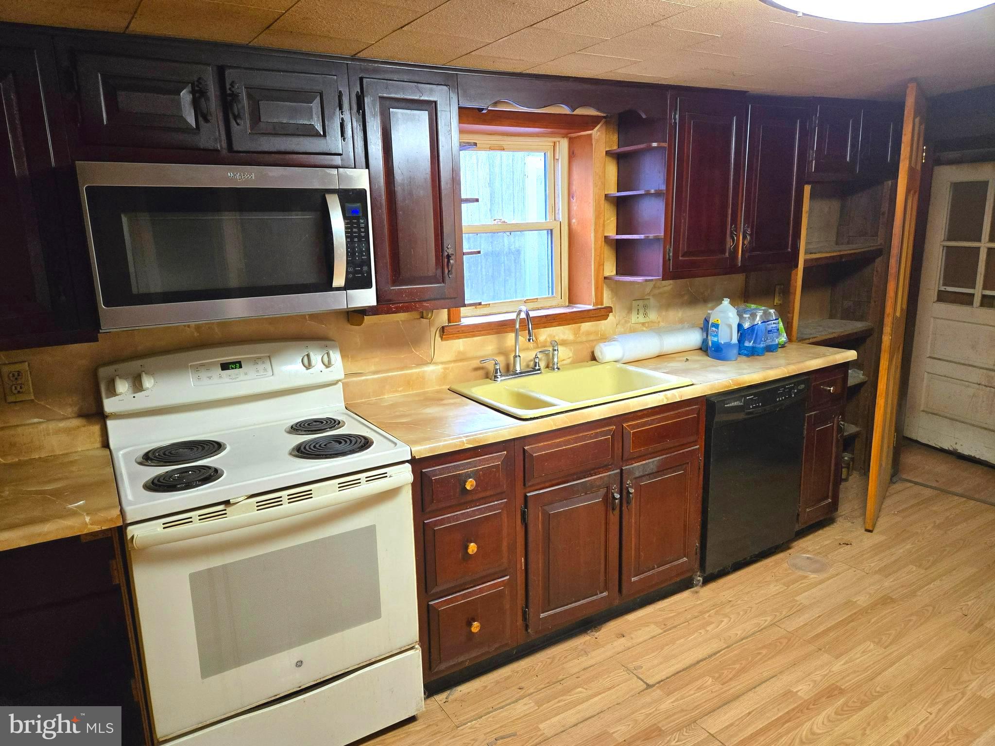 196 Foster Drive Falling Waters, WV 25419 - Photo 43 of 50 a kitchen with stainless steel appliances wooden cabinets and a stove top oven