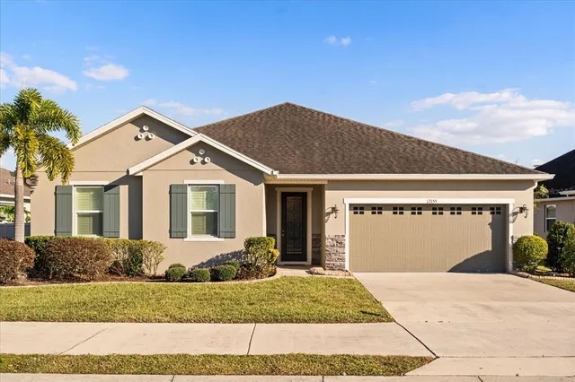 a front view of a house with a yard and garage