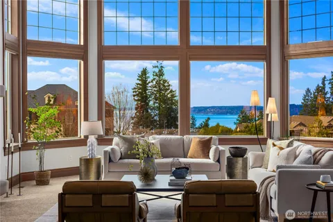 a living room with furniture a lamp and a window