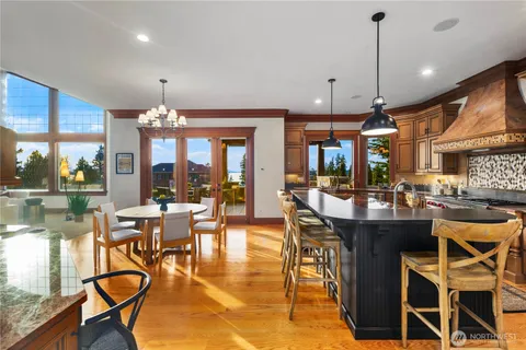 a view of a dining room with furniture wooden floor and a chandelier