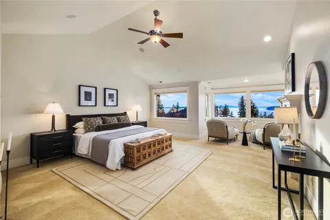 a living room with furniture and floor to ceiling windows