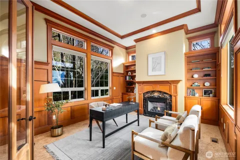 a living room with furniture a fireplace and next to a window