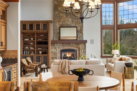 a living room with furniture a fireplace and a large window
