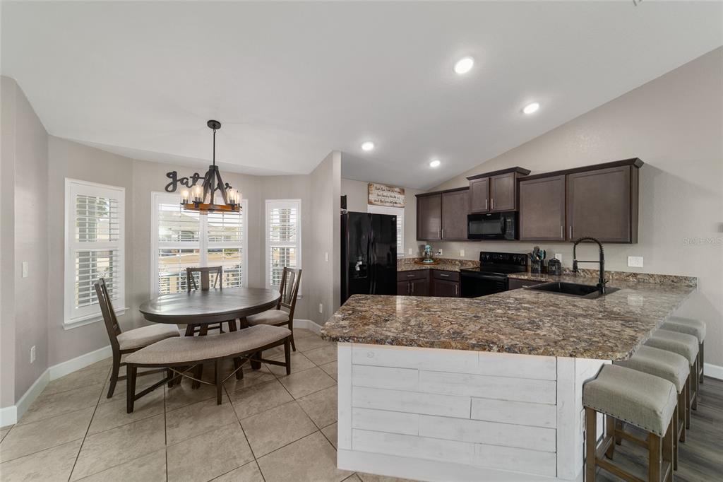 9155 Southeast 47th Court Road Ocala, FL 34480 - Photo 11 of 47 a kitchen with granite countertop kitchen island stainless steel appliances a sink and counter space