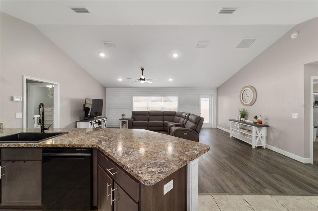 9155 Southeast 47th Court Road Ocala, FL 34480 - Photo 16 of 47 a kitchen with granite countertop living room and living room