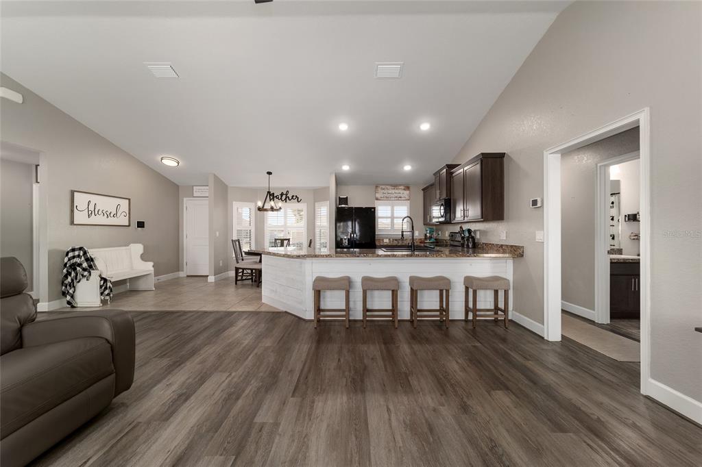 9155 Southeast 47th Court Road Ocala, FL 34480 - Photo 20 of 47 a living room with kitchen island furniture and a wooden floor