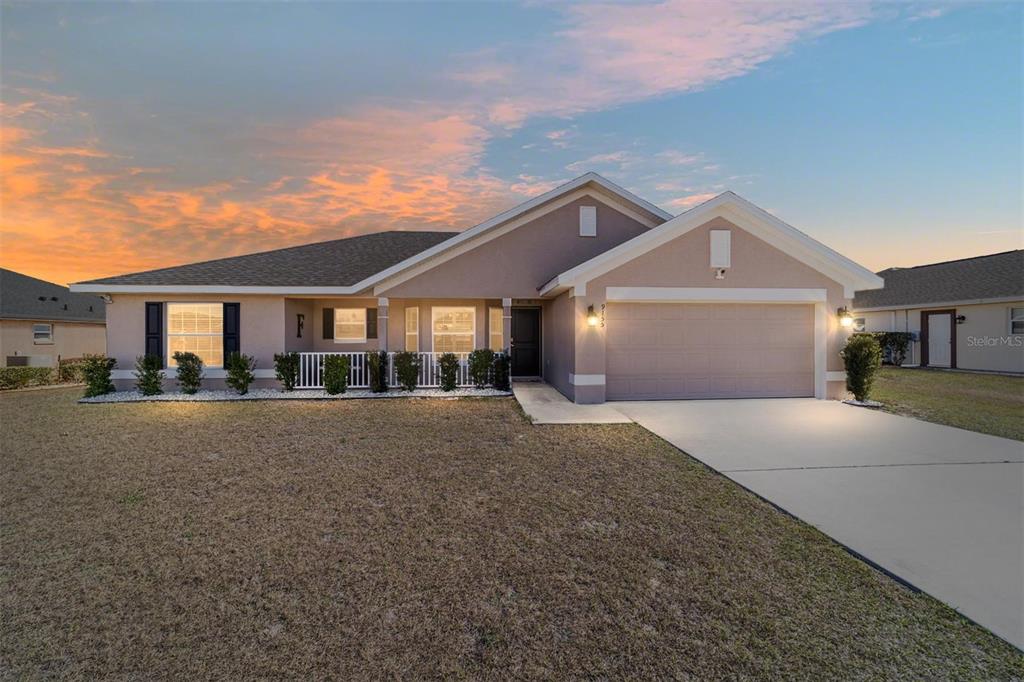 9155 Southeast 47th Court Road Ocala, FL 34480 - Photo 2 of 47 a front view of a house with a yard and garage