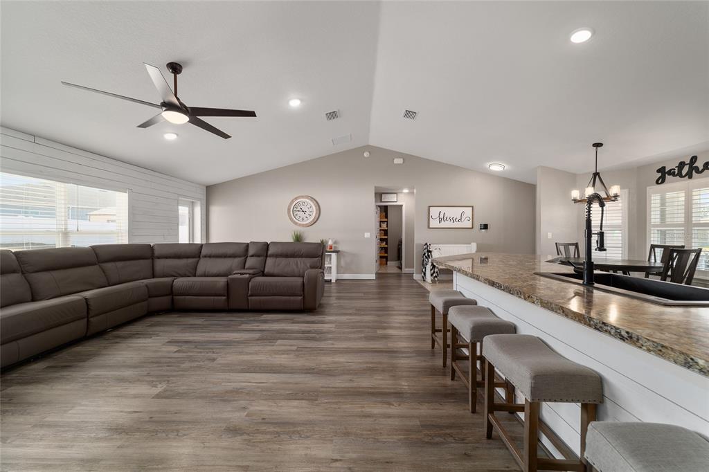 9155 Southeast 47th Court Road Ocala, FL 34480 - Photo 21 of 47 a living room with couches and kitchen view with wooden floor
