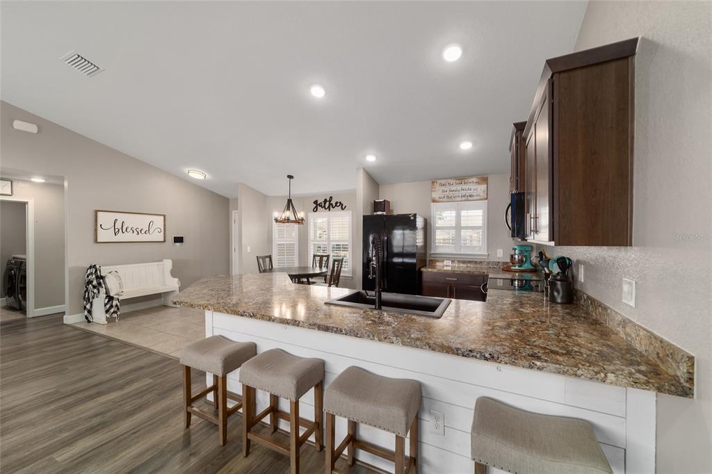 9155 Southeast 47th Court Road Ocala, FL 34480 - Photo 22 of 47 a kitchen with counter space dining table and chairs