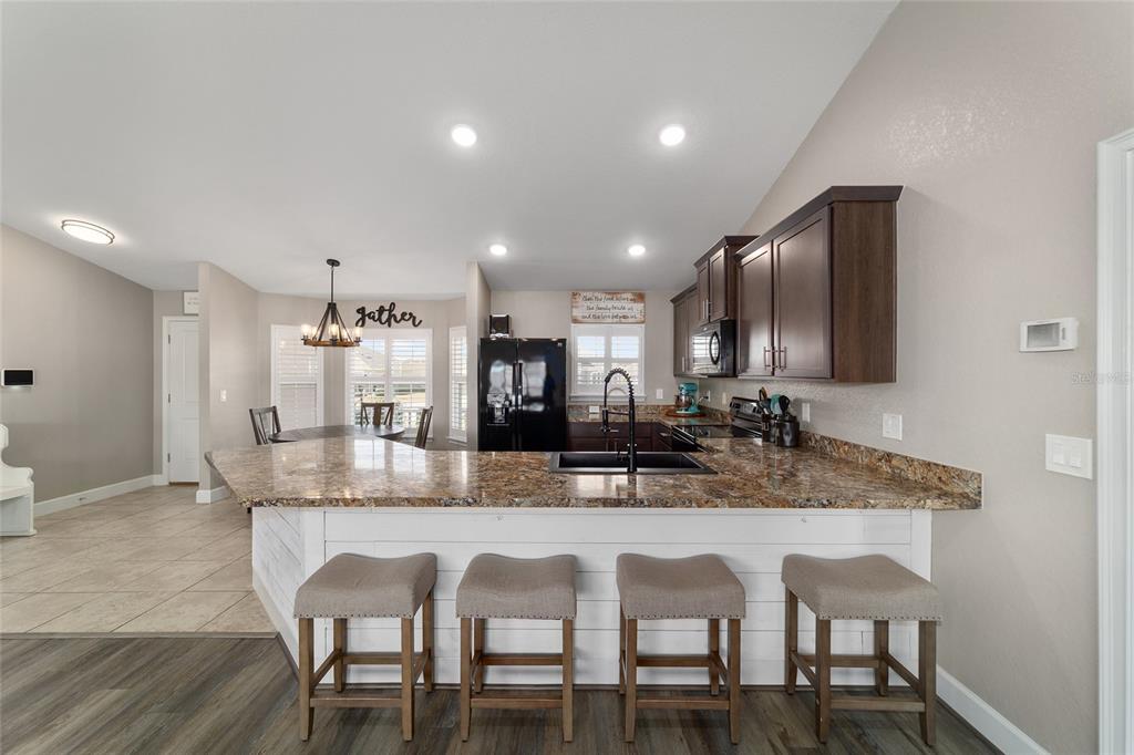 9155 Southeast 47th Court Road Ocala, FL 34480 - Photo 23 of 47 a dining room with kitchen island granite countertop furniture and kitchen view