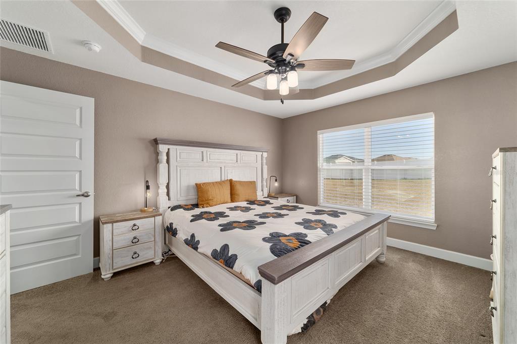 9155 Southeast 47th Court Road Ocala, FL 34480 - Photo 25 of 47 a bed sitting in a bedroom next to a window