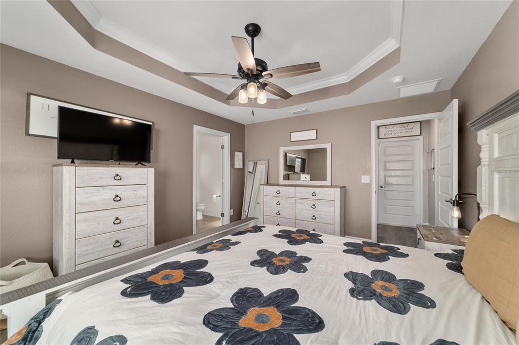 9155 Southeast 47th Court Road Ocala, FL 34480 - Photo 27 of 47 a bedroom with a bed and a television