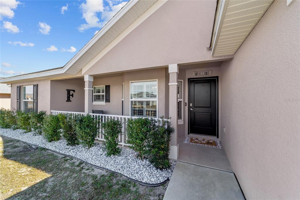9155 Southeast 47th Court Road Ocala, FL 34480 - Photo 4 of 47 a front view of a house with garden