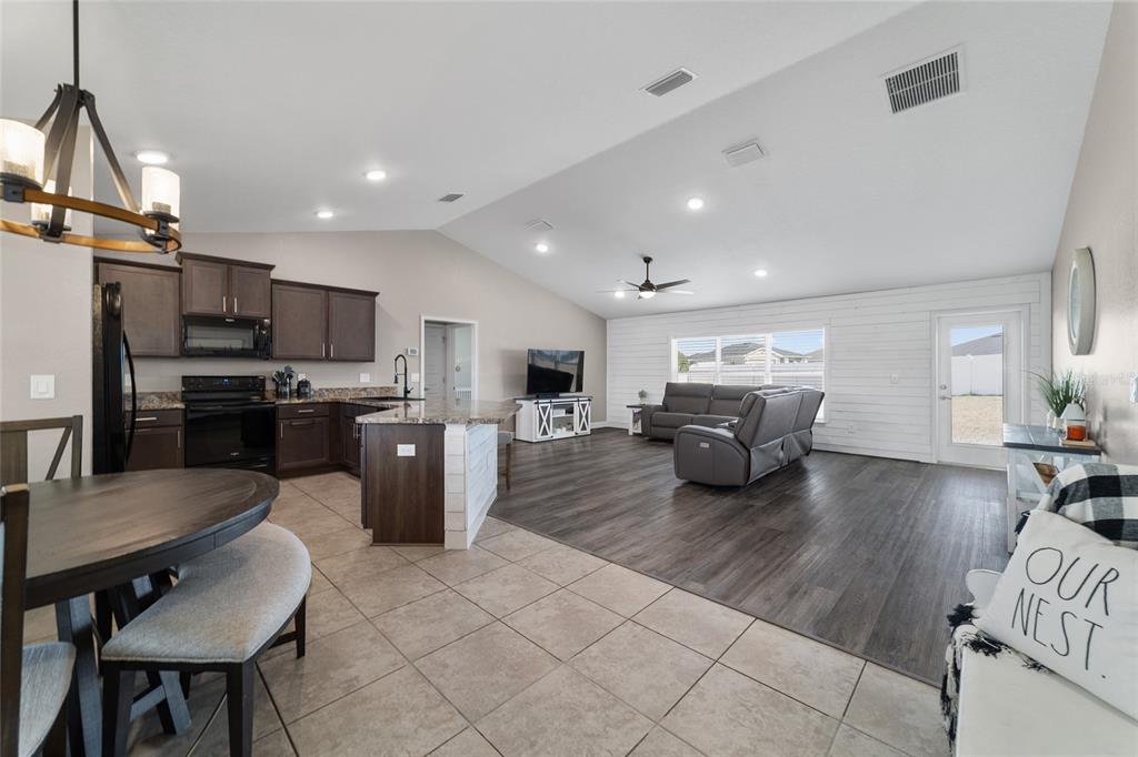 9155 Southeast 47th Court Road Ocala, FL 34480 - Photo 7 of 47 a living room with stainless steel appliances furniture or kitchen view and a chandelier