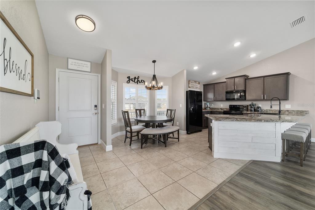 9155 Southeast 47th Court Road Ocala, FL 34480 - Photo 8 of 47 a living room with stainless steel appliances kitchen island granite countertop furniture and a view of kitchen