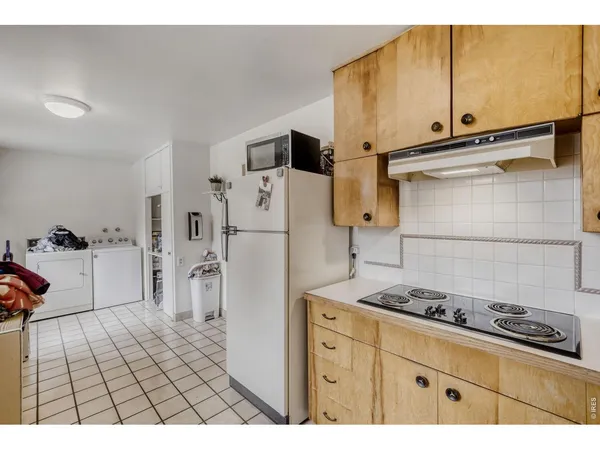 a kitchen with stainless steel appliances granite countertop a refrigerator and a stove