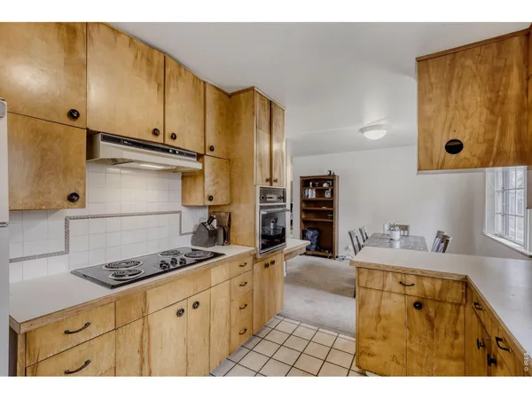 a kitchen with stainless steel appliances a stove a sink and a refrigerator
