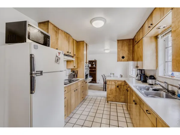 a kitchen with stainless steel appliances a refrigerator sink and cabinets
