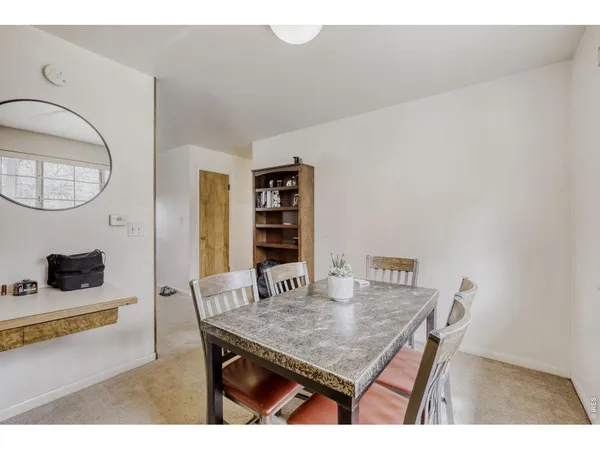 a dining room with a table and chairs