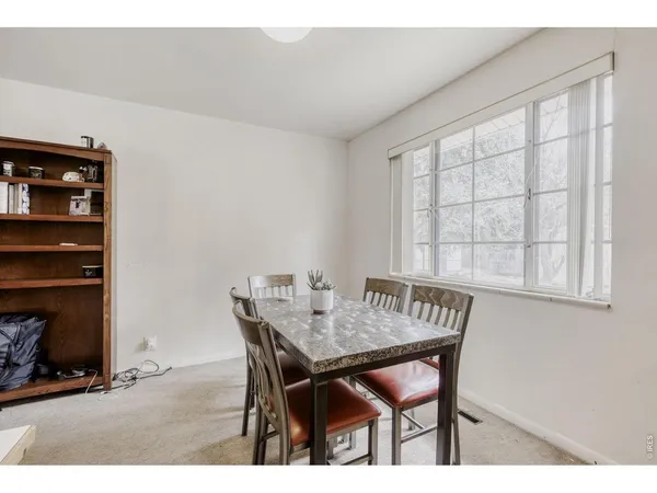 a view of a dining room with furniture and window