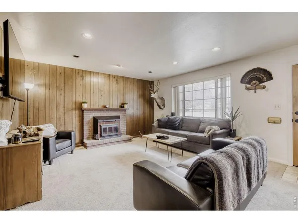 a living room with furniture flat screen tv and fireplace