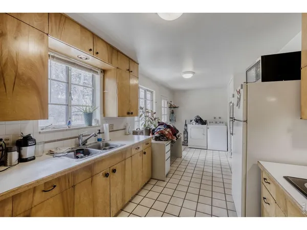 a kitchen with a sink a refrigerator and a stove