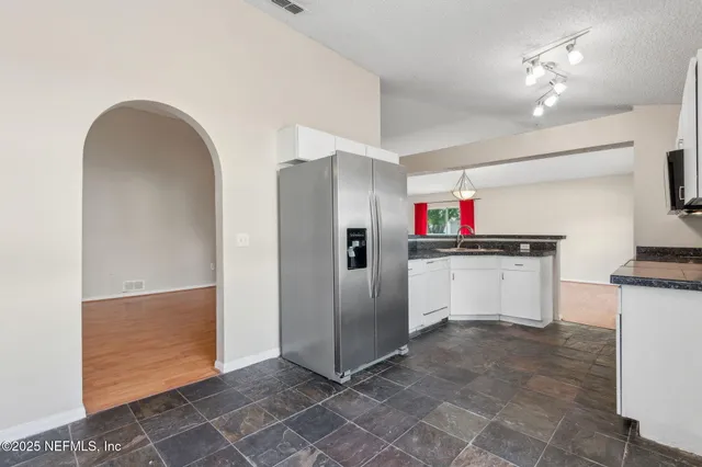 a view of cabinets with stainless steel appliances cabinets and empty room