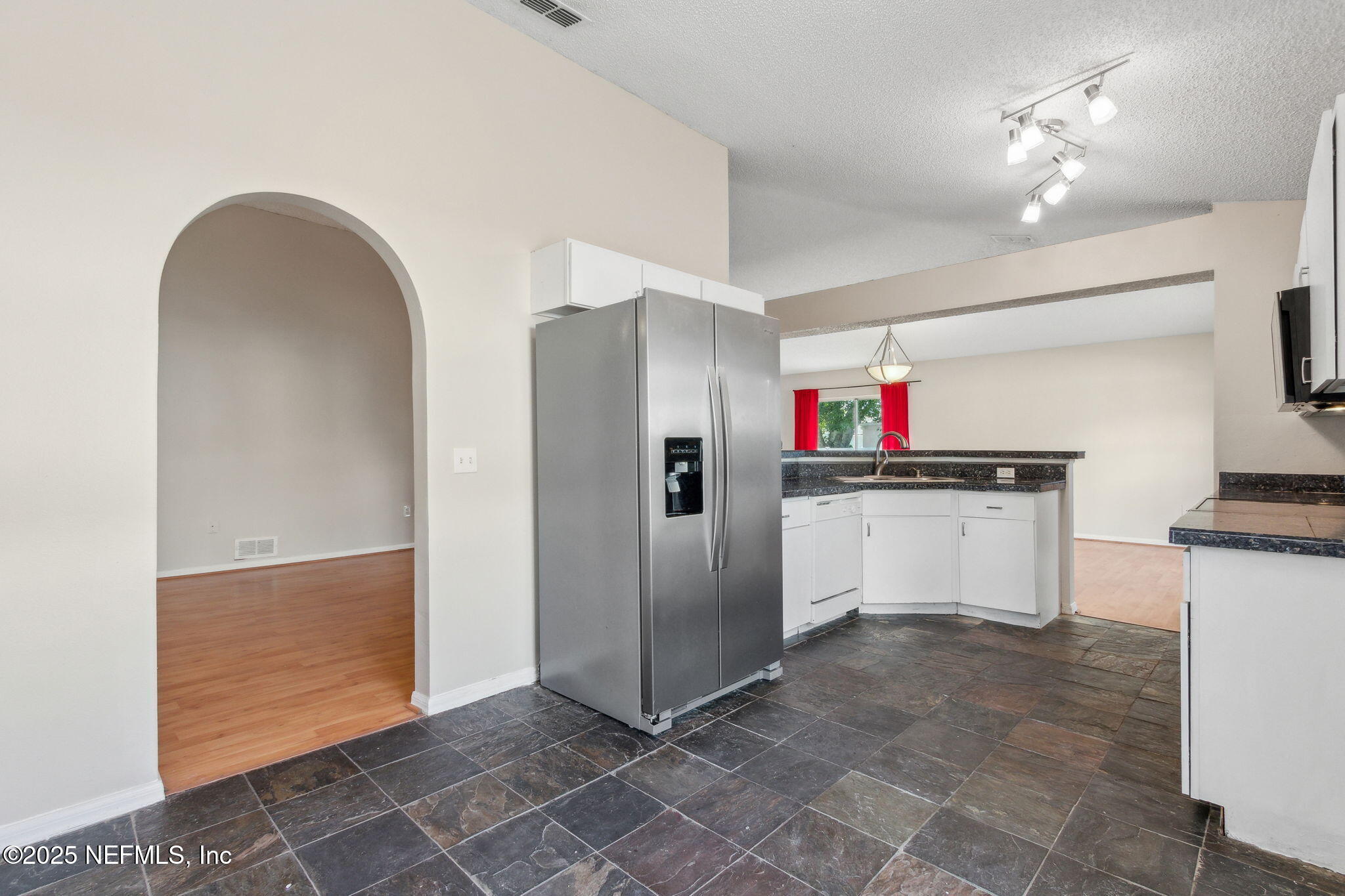 7364 Edenfield Park Road Jacksonville, FL 32244 - Photo 13 of 31 a view of cabinets with stainless steel appliances cabinets and empty room