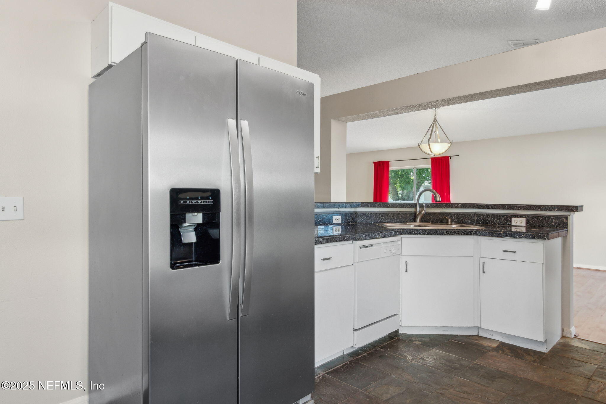 7364 Edenfield Park Road Jacksonville, FL 32244 - Photo 15 of 31 a kitchen with stainless steel appliances granite countertop a sink and a refrigerator