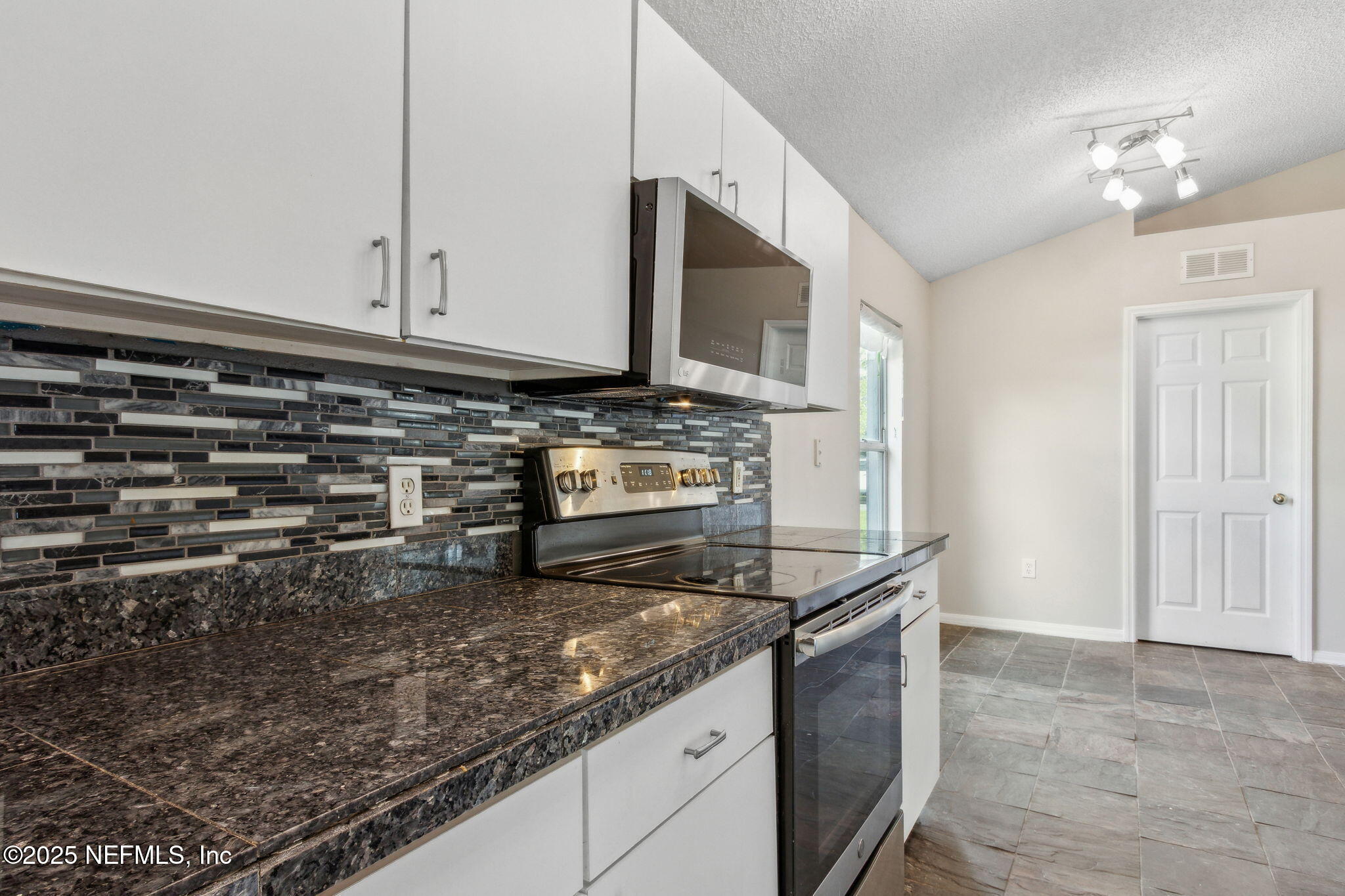 7364 Edenfield Park Road Jacksonville, FL 32244 - Photo 16 of 31 a kitchen with granite countertop a sink and a stove