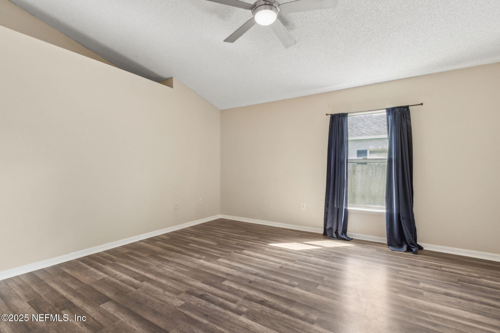 7364 Edenfield Park Road Jacksonville, FL 32244 - Photo 18 of 31 an empty room with wooden floor and fan