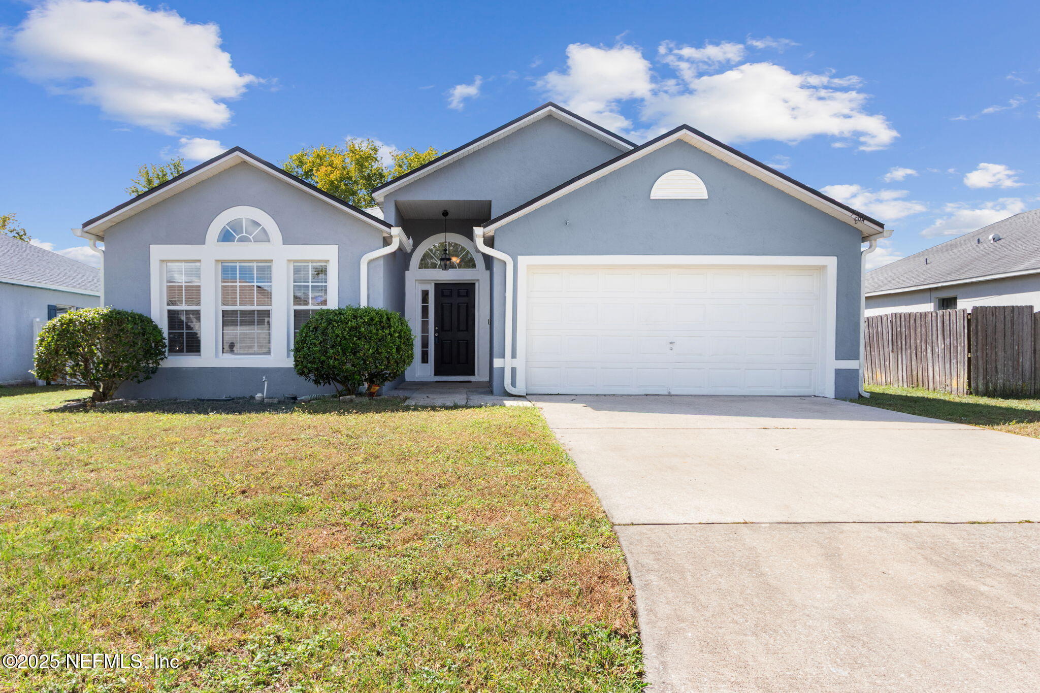 7364 Edenfield Park Road Jacksonville, FL 32244 - Photo 2 of 31 a front view of a house with a yard and garage