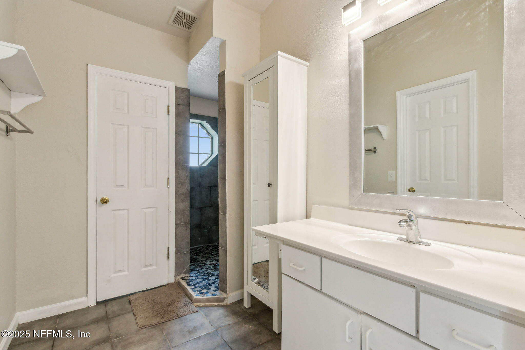 7364 Edenfield Park Road Jacksonville, FL 32244 - Photo 22 of 31 a bathroom with a sink and a mirror