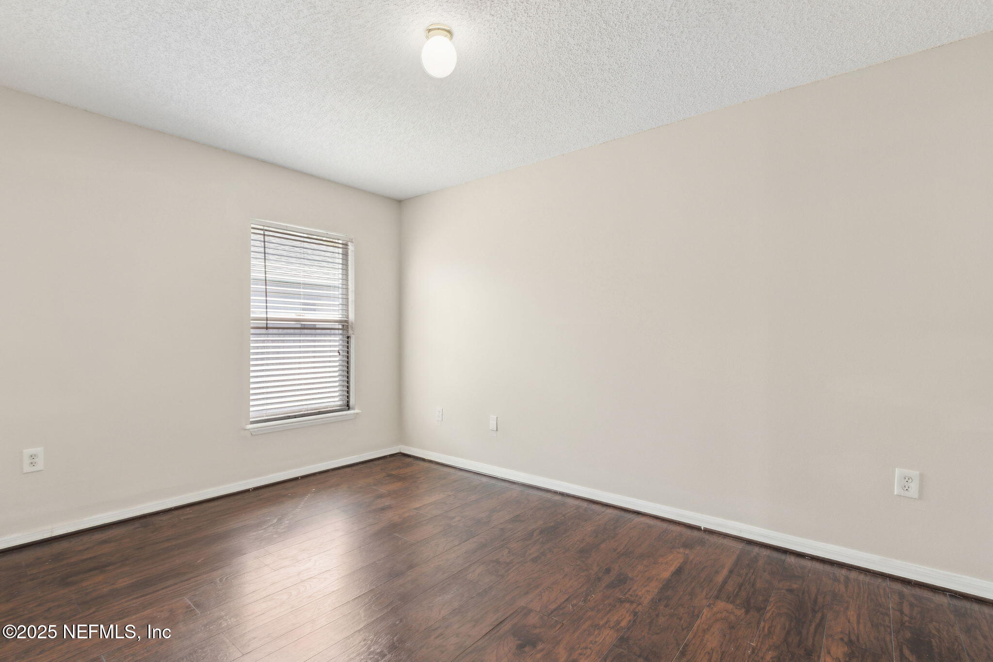 7364 Edenfield Park Road Jacksonville, FL 32244 - Photo 24 of 31 an empty room with wooden floor and windows