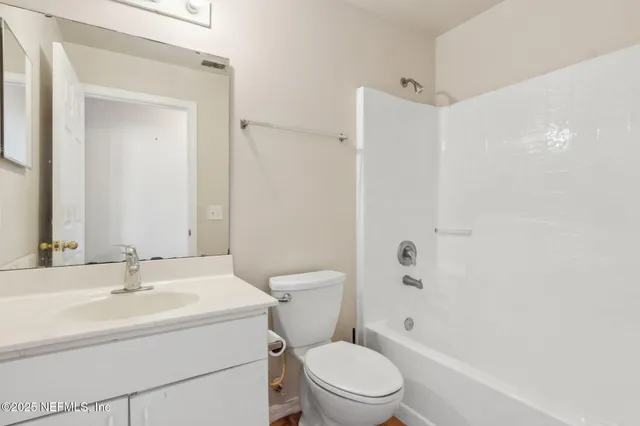 a white toilet sitting next to a bathroom sink