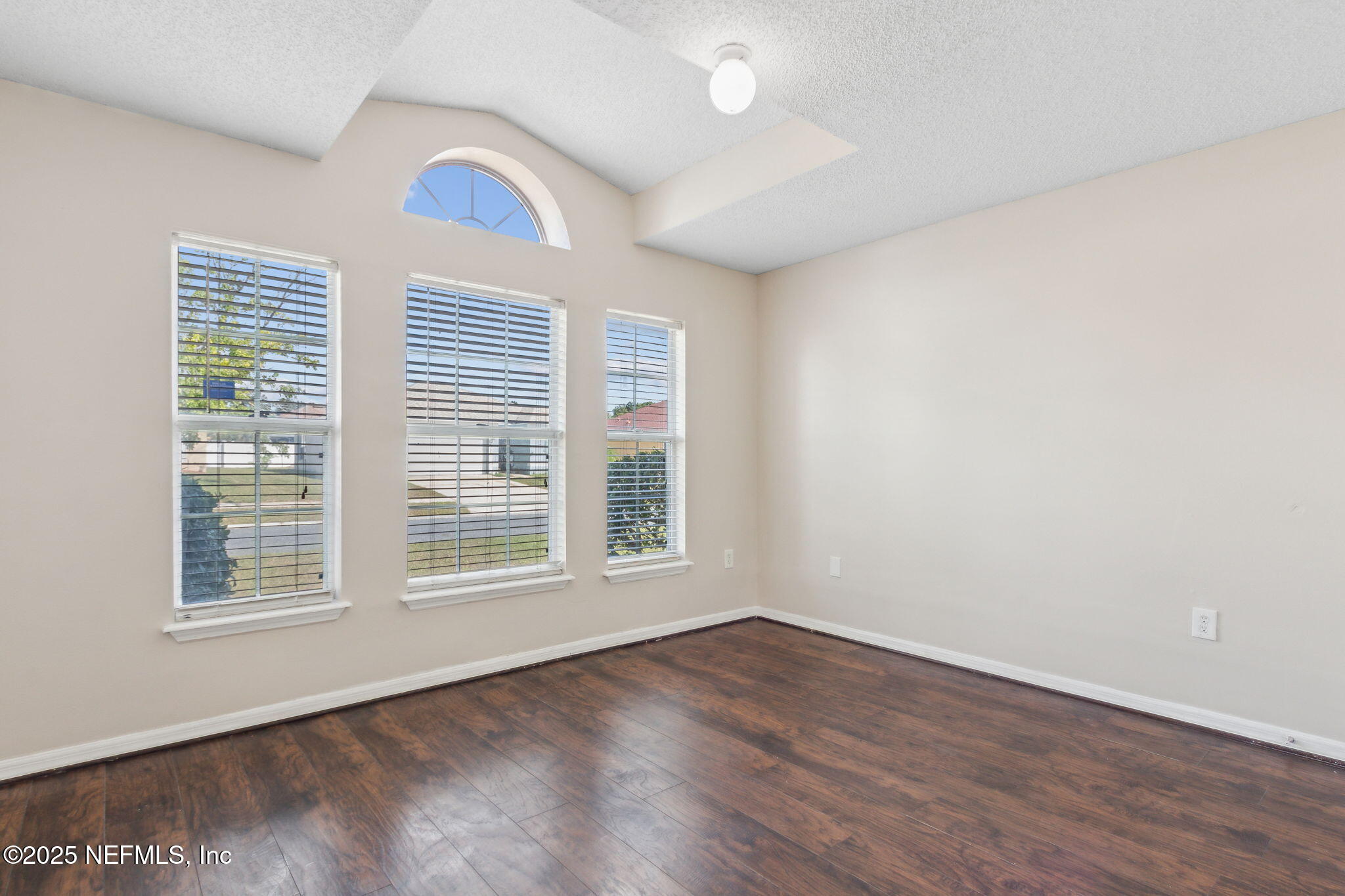 7364 Edenfield Park Road Jacksonville, FL 32244 - Photo 27 of 31 an empty room with wooden floor and windows