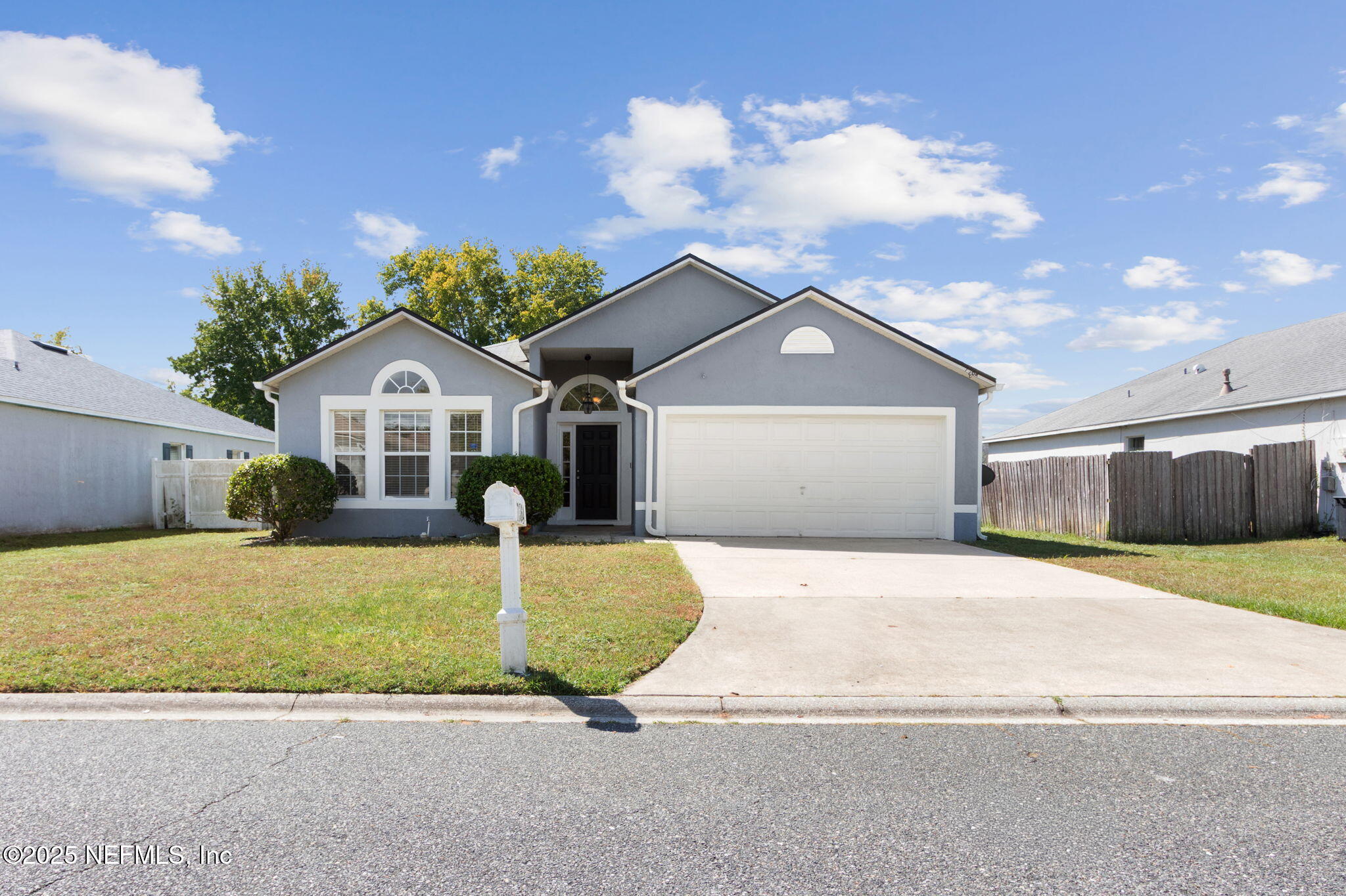7364 Edenfield Park Road Jacksonville, FL 32244 - Photo 3 of 31 a front view of a house with a yard and garage