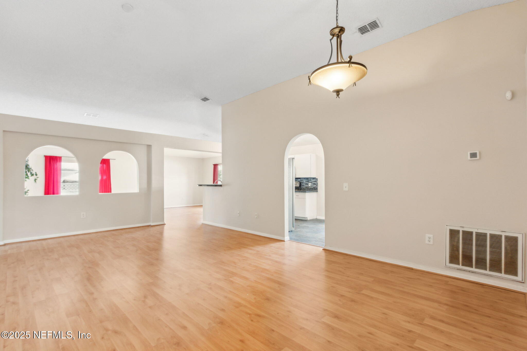 7364 Edenfield Park Road Jacksonville, FL 32244 - Photo 4 of 31 a view of an empty room with wooden floor and windows